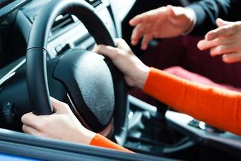 The passenger of a car getting angry with the driver