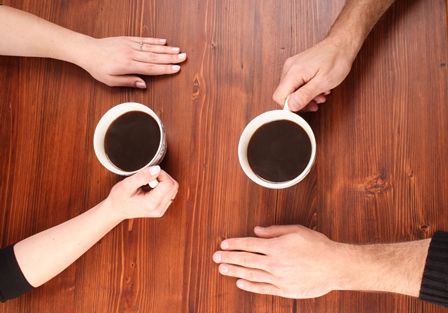 a couple sitting and drinking coffee together
