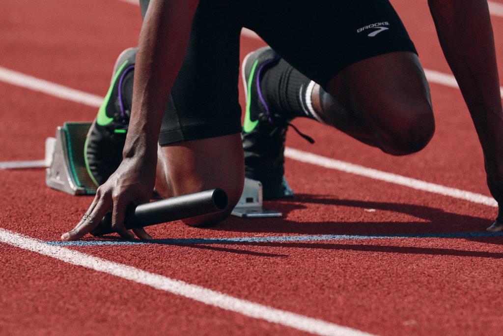 A running getting ready to run a race on a track.