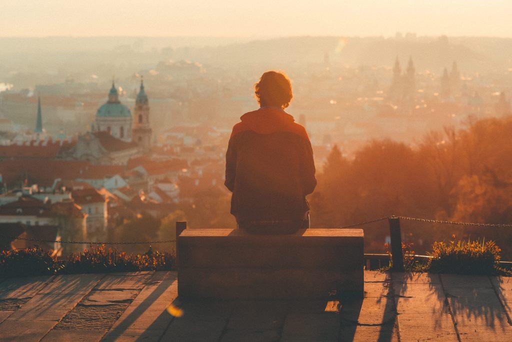 A man looking off into the distance at a city.