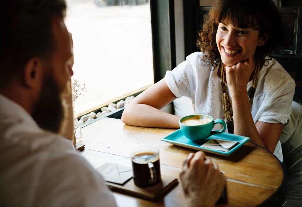 A couple on a date at a coffee shop.