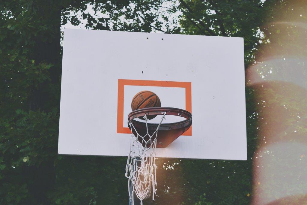 A basketball in a basketball hoop.