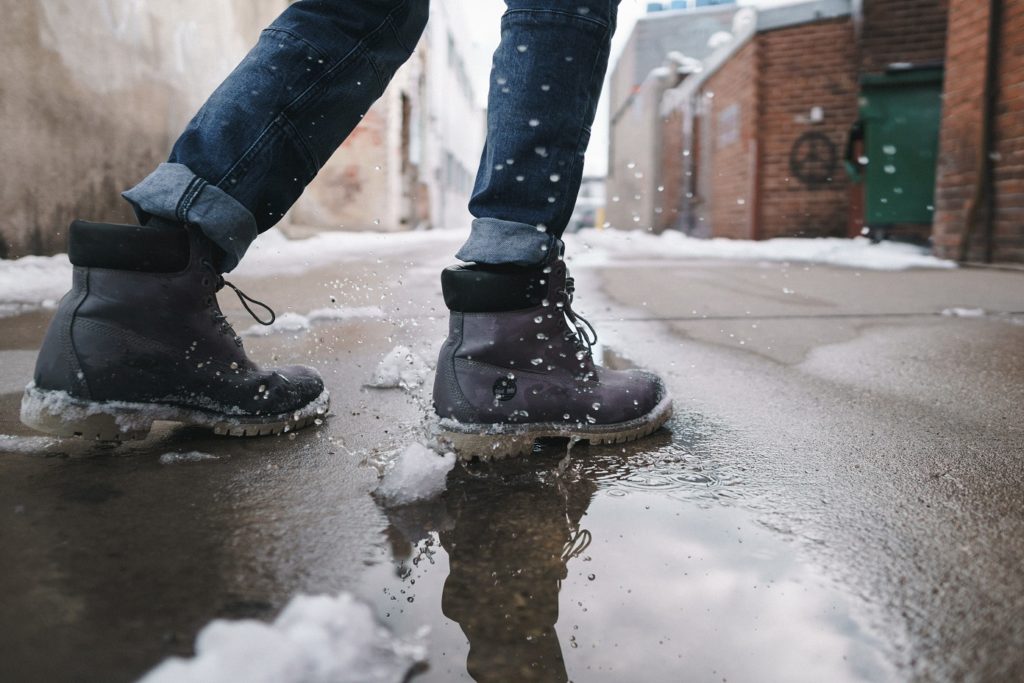 Boots splashing in a puddle.