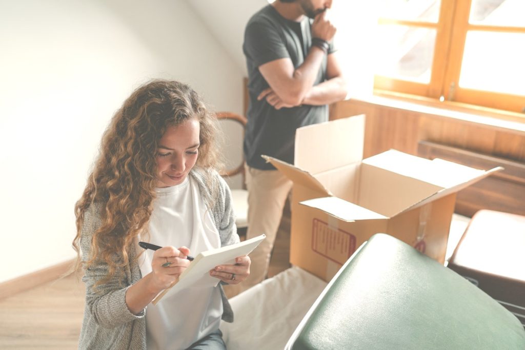 A couple with a moving box.