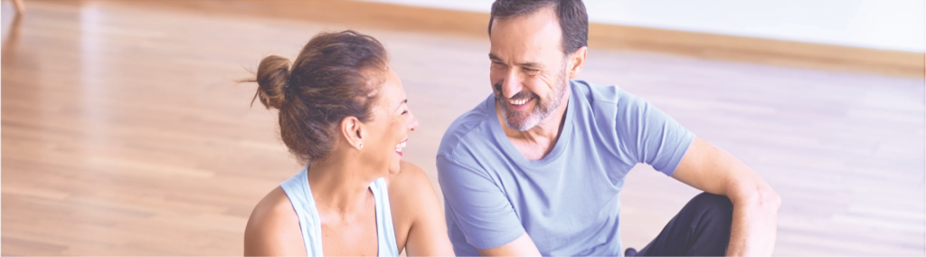 couple sitting on exercise mat