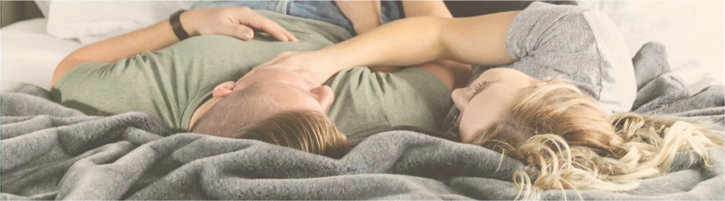 couple cuddling on their bed