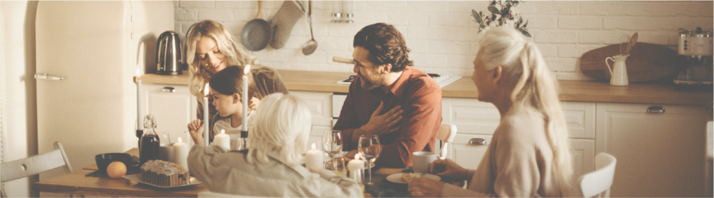 Family Sits on Table Inside Kitchen