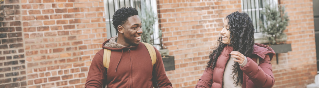 couple with good communication holding hands while walking on urban pavement