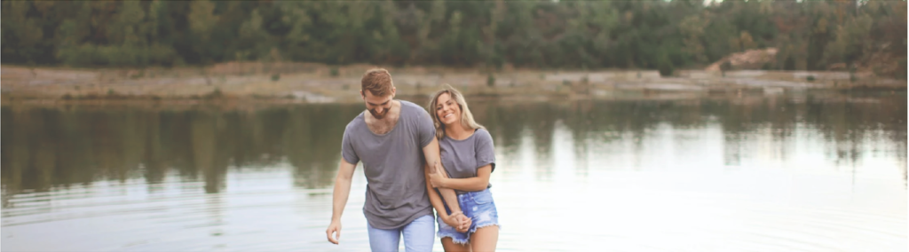 Couple Walking in Shallow Water and Smiling expectations