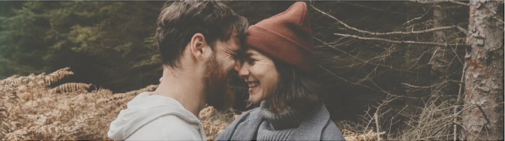 couple nose to nose in brown grass field