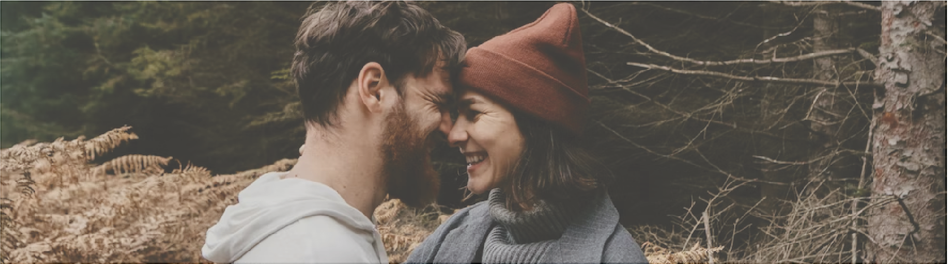 couple nose to nose in brown grass field