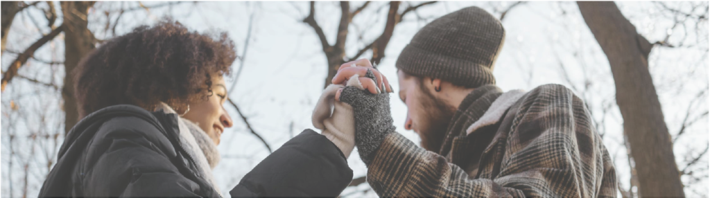 Couple holding hands outdoors winter
